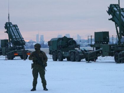 A soldier stands in front of PATRIOT (Phased Array Tracking Radar to Intercept on Target) surface-to-air missile systems during a military exercise at Warsaw Babice Airport, Poland on February 7, 2023. - Patriot missile systems purchased by Poland last year have been redeployed to the Polish captital for military exercises. …