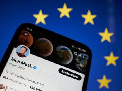 In this photo illustration Elon Musk Twitter seen displayed on a smartphone screen with the flag of European Union (EU) in the background in Athens, Greece on March 8, 2023. The European Union is asking Elon Musk to hire staff at Twitter. (Photo Illustration by Nikolas Kokovlis/NurPhoto via Getty Images)