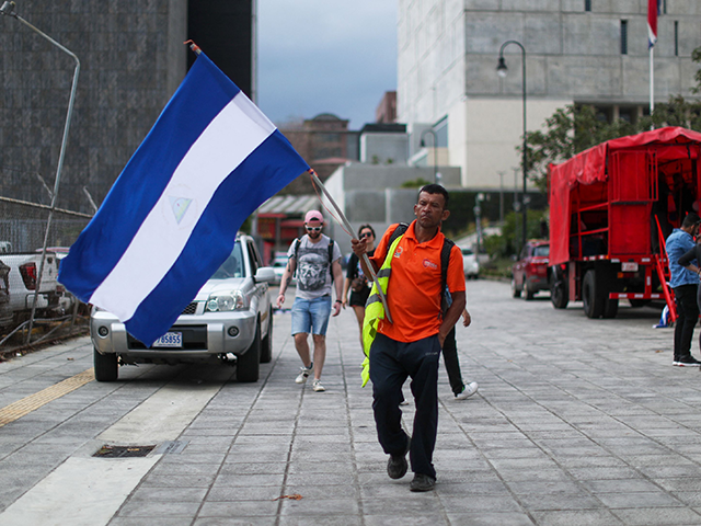 A man waves a Nicaraguan flag during a demonstration to commemorate Nicaragua's natio