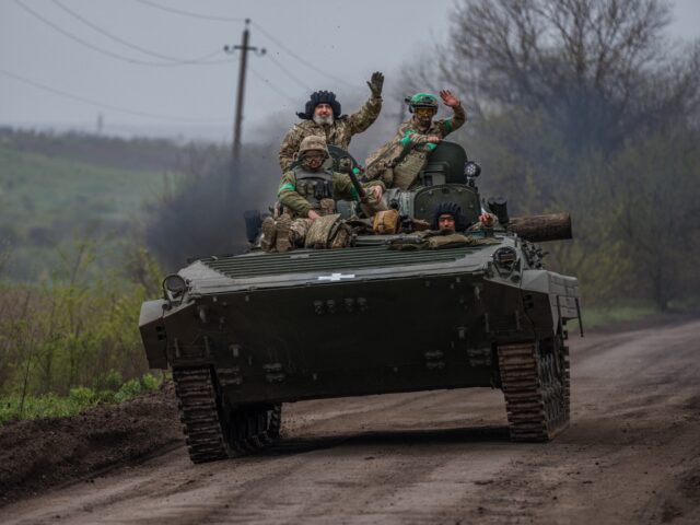 Ukrainian servicemen ride in a BMP infantry fighting vehicle near the town of Bakhmut, in