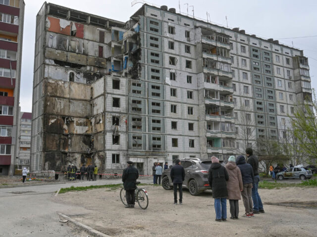 UMAN, UKRAINE - 2023/04/30: People stand near destroyed house that was damaged as a result