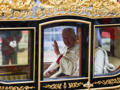 King Charles III waves from the Diamond Jubilee carriage, on the day of the coronation of