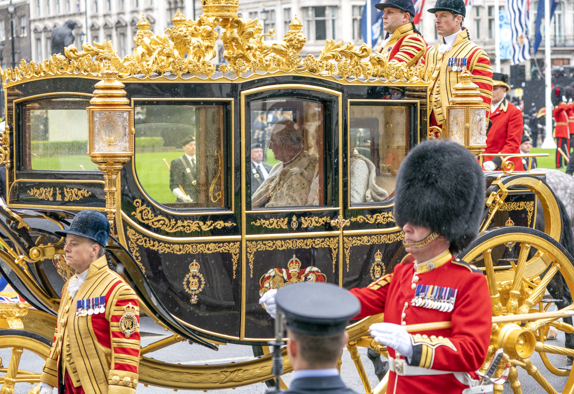 LONDON, ENGLAND - MAY 06: King Charles III and Camilla, Queen Consort are carried in the Diamond Jubilee State Coach as the King's procession passes Parliament Square ahead of the Coronation at Westminster Abbey on May 6, 2023 in London, England. The Coronation of Charles III and his wife, Camilla, as King and Queen of the United Kingdom of Great Britain and Northern Ireland, and the other Commonwealth realms takes place at Westminster Abbey today. Charles acceded to the throne on 8 September 2022, upon the death of his mother, Elizabeth II. (Photo by Jane Barlow - WPA Pool/Getty Images)
