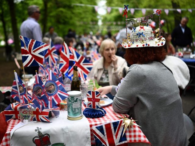 Members of the public wearing Union Jack themed items take part in a Coronation Big Lunch