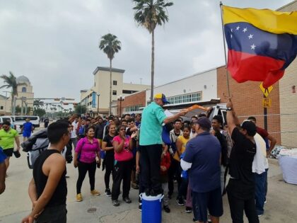 A group of Venezuelan migrants receive food and assistance from a local church in downtown Brownsville, Texas, on May 6, 2023. - Migrants crossed the Rio Grande and surrendered to Customs and Border Patrol agents a few days ago. Then they were taken to a detention center and released on …