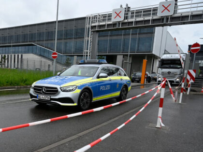 A police car leaves the grounds of the Factory 56 at the plant of German car maker Mercedes-Benz in Sindelfingen, southern Germany, after shots were fired at the plant on May 11, 2023. One person was killed and another seriously injured at the factory, police said, adding that a suspect …