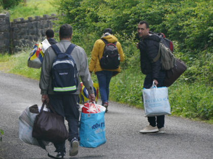 Asylum seekers, who told reporters they were heading for Dublin, leaving the grounds of th