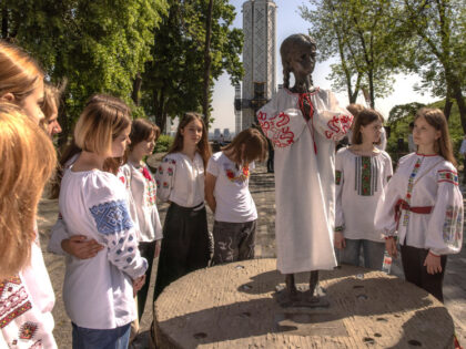 KYIV, UKRAINE - MAY 18: People wearing Ukrainian ethnic embroidered clothes gather next to the statue of "Girl with Ears of Grain" dressed in Vyshyvanka at the site of the National Museum of the Holodomor-Genocide during Vyshyvanka Day on May 18, 2023 in Kyiv, Ukraine. Vyshyvanka Day, which started in …