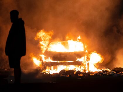 CARDIFF, WALES - MAY 23: An automobile burns on Highmead Road during unrest following a serious road crash earlier on Snowden Road on May 23, 2023 in Cardiff, Wales. Riot Police with dogs are trying to contain a large group of people causing serious disorder in Ely, Cardiff tonight. Fires …