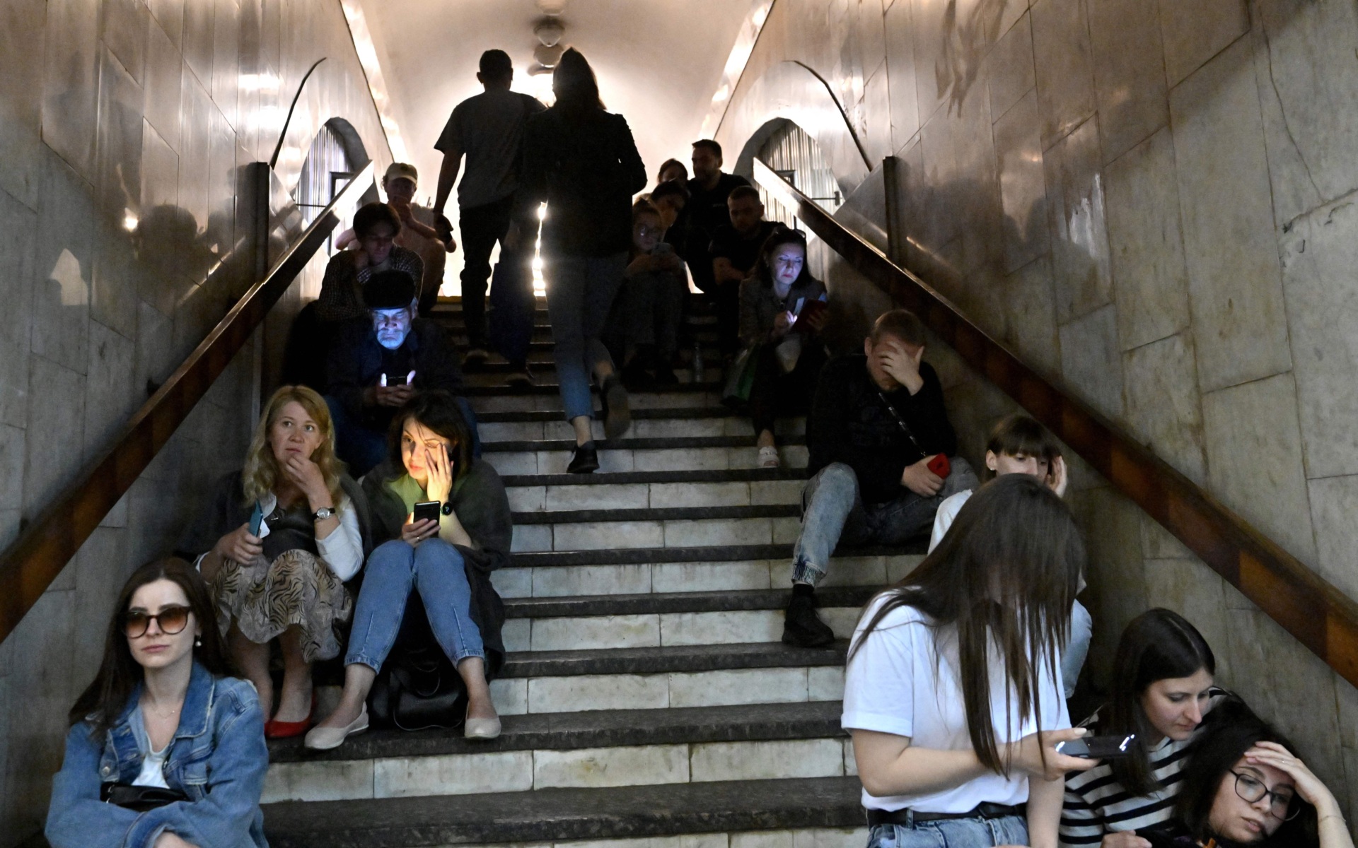 Local residents take shelter in a metro station in the center of Kyiv during a Russian missile strike on May 29, 2023. Russia fired a barrage of missiles at Kyiv on Monday sending panicked residents running for shelter in an unusual daytime attack on the Ukrainian capital following overnight strikes. (Photo by Sergei SUPINSKY / AFP) (Photo by SERGEI SUPINSKY/AFP via Getty Images)