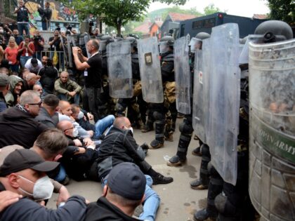 TOPSHOT - Serbs from Kosovo face riot police during their gathering to demand the removal