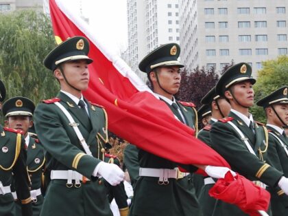 XINING, CHINA - OCTOBER 01: Soldiers of the People's Liberation Army (PLA) honor guard perform the flag-raising ceremony at a square to mark the 71st Anniversary of the Founding of the People's Republic of China on October 1, 2020 in Xining, Qinghai Province of China. China celebrates National Day and …