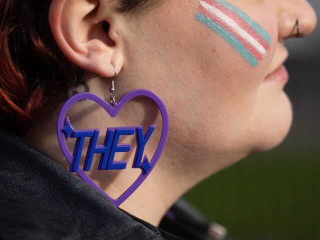 LONDON, ENGLAND - JANUARY 17: A Trans rights activist wears an earring featuring a 'they'