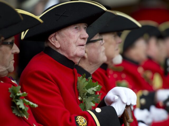 Chelsea Pensioners, British veteren soldiers, sit wearing their oak leaf sprigs during the