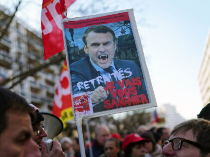 LILLE, FRANCE - FEBRUARY 07: A demonstrator holds a panel with a picture of french President Emmanuel Macron reading "pensioners, I will bleed you"as demonstrators march through the streets of Lille in protest of the pension reform on February 07, 2023 in Lille, France. Protests have been taking place across …