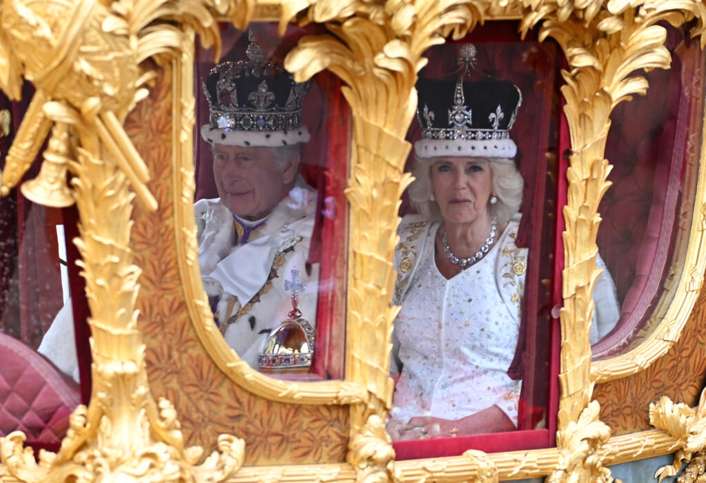 LONDON, ENGLAND - MAY 06: King Charles III and Queen Camilla travelling in the Gold State Coach built in 1760 and used at every Coronation since that of William IV in 1831sets off from Westminster Abbey on route to Buckingham Palace during the Coronation of King Charles III and Queen Camilla on May 06, 2023 in London, England. The Coronation of Charles III and his wife, Camilla, as King and Queen of the United Kingdom of Great Britain and Northern Ireland, and the other Commonwealth realms takes place at Westminster Abbey today. Charles acceded to the throne on 8 September 2022, upon the death of his mother, Elizabeth II. (Photo by Stuart C. Wilson/Getty Images)