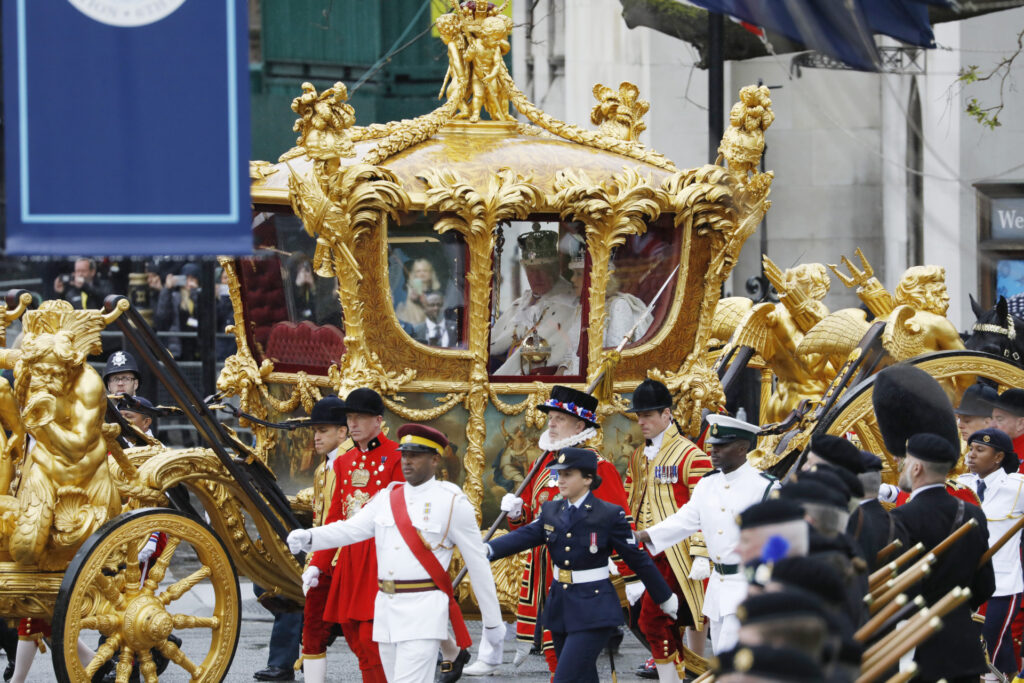 LONDON, ENGLAND - MAY 06: King Charles III and Queen Camilla travelling in the Gold State Coach built in 1760 and used at every Coronation since that of William IV in 1831sets off from Westminster Abbey on route to Buckingham Palace during the Coronation of King Charles III and Queen Camilla on May 06, 2023 in London, England. The Coronation of Charles III and his wife, Camilla, as King and Queen of the United Kingdom of Great Britain and Northern Ireland, and the other Commonwealth realms takes place at Westminster Abbey today. Charles acceded to the throne on 8 September 2022, upon the death of his mother, Elizabeth II. (Photo by Tristan Fewings/Getty Images)