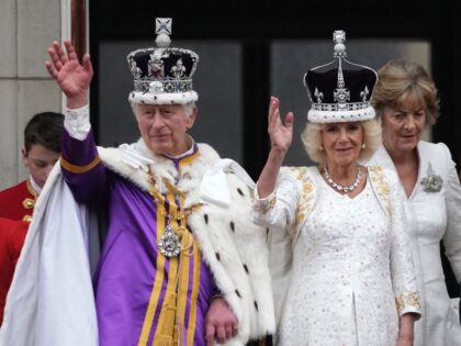 LONDON, ENGLAND - MAY 06: King Charles III and Queen Camilla can be seen on the Buckingham Palace balcony ahead of the flypast during the Coronation of King Charles III and Queen Camilla on May 06, 2023 in London, England. The Coronation of Charles III and his wife, Camilla, as …