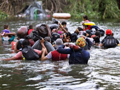 MATAMOROS, MEXICO - MAY 11: Migrants swim across the Rio Grande as they try to enter the U
