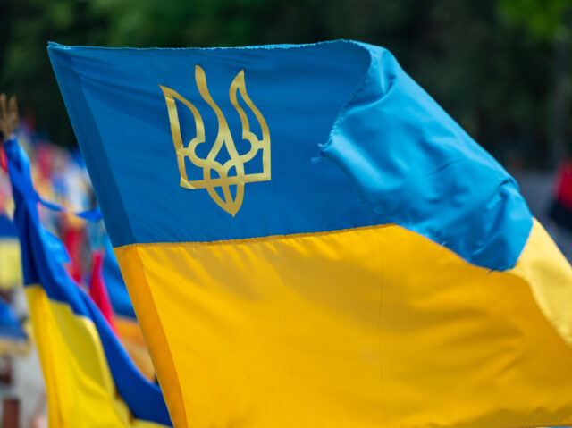 LVIV, UKRAINE - MAY 12: The flag of Ukraine flies on the grave of a Ukrainian soldier during the funeral ceremony at the Lychakiv cemetery on May 12, 2023 in Lviv, Ukraine. On May 10, at the age of 95, Kateryna Shcherba (pseudonym Olesya), who was a liaison officer of …