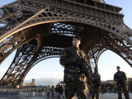 French soldiers patrol in front of the Eiffel Tower on January 8, 2015 in Paris as the capital was placed under the highest alert status a day after heavily armed gunmen shouting Islamist slogans stormed French satirical newspaper Charlie Hebdo and shot dead at least 12 people in the deadliest …