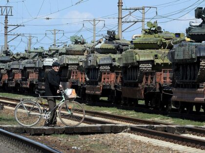 A man stands near a trainload of modified T-72 Russian tanks after their arrival in Gvarde