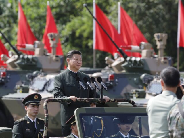 Xi Jinping, China's president, rides in a vehicle as he reviews People's Liberation Army (