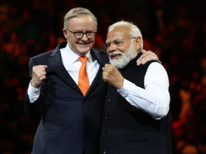 India's Prime Minister Narendra Modi (R) and Australia's Prime Minister Anthony Albanese gesture during an event with members of the local Indian community at the Qudos Arena in Sydney on May 23, 2023. Australia vowed to take ties with India to the "next level" on May 23 as it hosted …