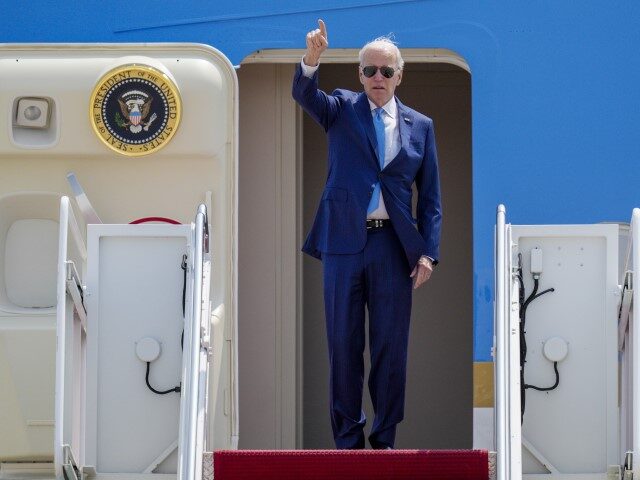 President Joe Biden gestures as he boards Air Force One at Andrews Air Force Base, Md., We