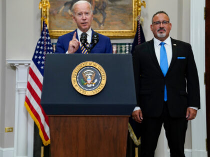 FILE - President Joe Biden speaks about student loan debt forgiveness in the Roosevelt Room of the White House, Aug. 24, 2022, in Washington. Education Secretary Miguel Cardona listens at right. The Black Lives Matter Global Network Foundation launched a new relief fund Monday, Dec. 12, 2022 aimed at Black …