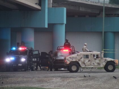 Mexican military, police, and immigration authorities gather on the south bank of the Rio Grande as the end of Title 42 nears. (Randy Clark/Breitbart Texas)
