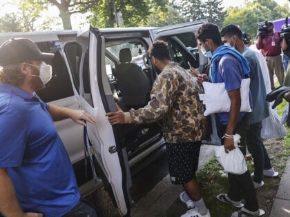 Migrants board a van outside the residence of VP Kamala Harris after being bused from the Texas border region. (File Photo: Getty Images)