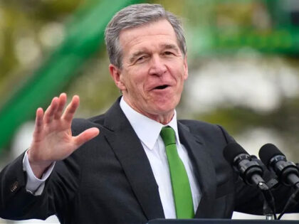 DURHAM, NC - MARCH 28: North Carolina Gov. Roy Cooper makes remarks to the crowd before U.S. President Joe Biden during a visit to Wolfspeed, a semiconductor manufacturer, as he kicks off his Investing in America Tour on March 28, 2023 in Durham, North Carolina. Biden asserts that his Investing …