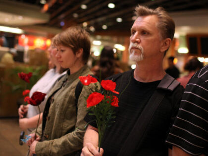 SAN FRANCISCO, CA - MAY 27: Veterans advocates stage a "flash mob" by holding poppy flowers and having a moment of silence inside the Westfield San Francisco Centre on May 27, 2011 in San Francisco, California. A group from San Francisco-based veteran rights organization Swords to Plowshares staged a "flash …