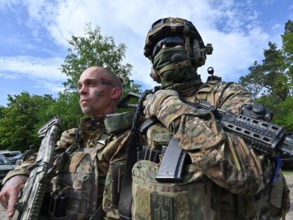TOPSHOT - Fighters of the Russian Volunteer Corps attend a presentation for the media in northern Ukraine, not far from the Russian border, on May 24, 2023, amid Russian military invasion on Ukraine. Russian nationals fighting on Ukraine's side on May 24 hailed as a "success" a brazen mission to …
