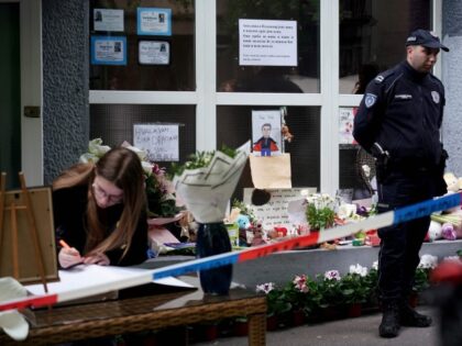 People sign the book of condolences outside the Vladislav Ribnikar elementary school in the capital Belgrade, on May 5, 2023, two days after a 13-year-old suspect shot dead eight fellow students and a security guard after allegedly drawing up a kill list. - Serbian President vowed to launch a large-scale …