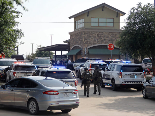 ALLEN, TEXAS - MAY 6: Emergency personnel work the scene of a shooting at Allen Premium Ou
