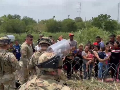 Texas Border Forces hold back migrants attempting to cross near Brownsville. (Twitter/Texas Governor Greg Abbott)