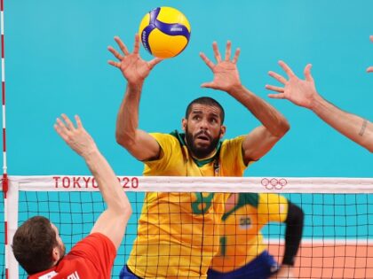 TOKYO, JAPAN - AUGUST 05: Wallace de Souza #8 of Team Brazil defends against the hit by Maxim Mikhaylov #17 of Team ROC during the Men's Semifinals volleyball on day thirteen of the Tokyo 2020 Olympic Games at Ariake Arena on August 05, 2021 in Tokyo, Japan.