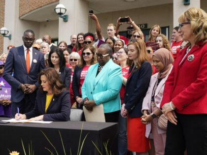 Michigan Gov. Gretchen Whitmer signs legislation, Monday, May 22, 2023, in Royal Oak, Mich. The package of legislation being signed will create extreme risk protection orders, which authorize family, police officers, or medical professionals to seek a court order to temporarily keep guns out of the hands of someone who …