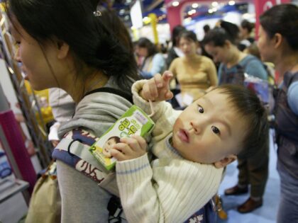 EOUL, SOUTH KOREA - FEBRUARY 17: A mothers carry her baby at a Pregnancy and Maternity exhibition ?Babyfair 2005? on February 17, 2005 in Seoul, South Korea. Babyfair 2005 has more than 350 exhibits comprised of companies, from South Korea and many other countries, showcasing all aspects of maternity and …
