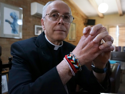 Bishop Mark Seitz of El Paso sits for a portrait in his office in El Paso, Texas, on Monday, April 4, 2022. The friendship bracelets on his wrist were braided by girls housed at a shelter on nearby Fort Bliss Army base for unaccompanied minors who crossed the U.S.-Mexican border. …