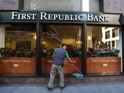 SAN FRANCISCO, CALIFORNIA - APRIL 26: A worker cleans the exterior of a First Republic ban