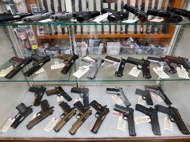 Semi-automatic handguns are displayed at shop in New Castle, Pa., March 25, 2020. A U.S. j