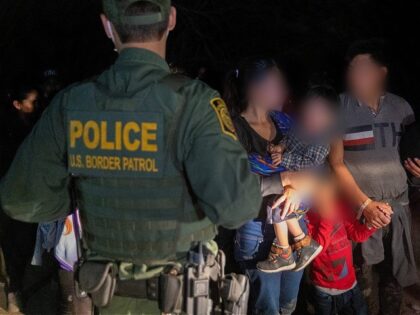 Border Patrol agents process a migrant family apprehended near Roma, Texas. (File Photo: John Moore/Getty Images)