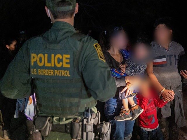 Border Patrol agents process a migrant family apprehended near Roma, Texas. (File Photo: J