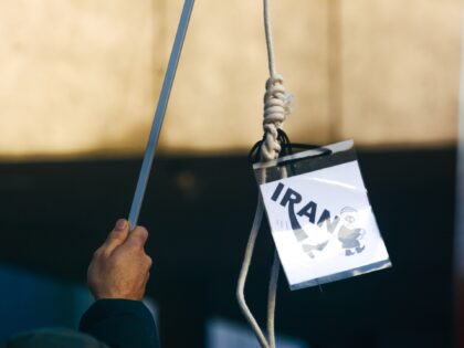 a man holds a hanging rope during the protest against Iran Islamic regime which marks the third anniversary of Ukrainian flight PS752 which was shot down by the Islamic revolutionary Guard and protest against execution of another two Iranian protesters in front of Dom Cathedral in Cologne, Germany on January …