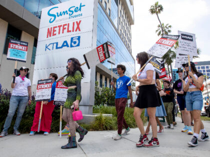 Writers Guild of America members and supporters on a picket line outside Netflix/Sunset Bronson Studios in the Hollywood area of Los Angeles, California, US, on Thursday, May 18, 2023. With the writers on the picket line, studios are now reducing payments to producers, the executives who create films and TV …