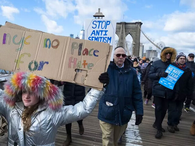 MANHATTAN, NY - JANUARY 05: A Marcher hold signs that reads "NYC No Place for Hater" and a