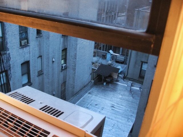 open window with air conditioner in NYC building